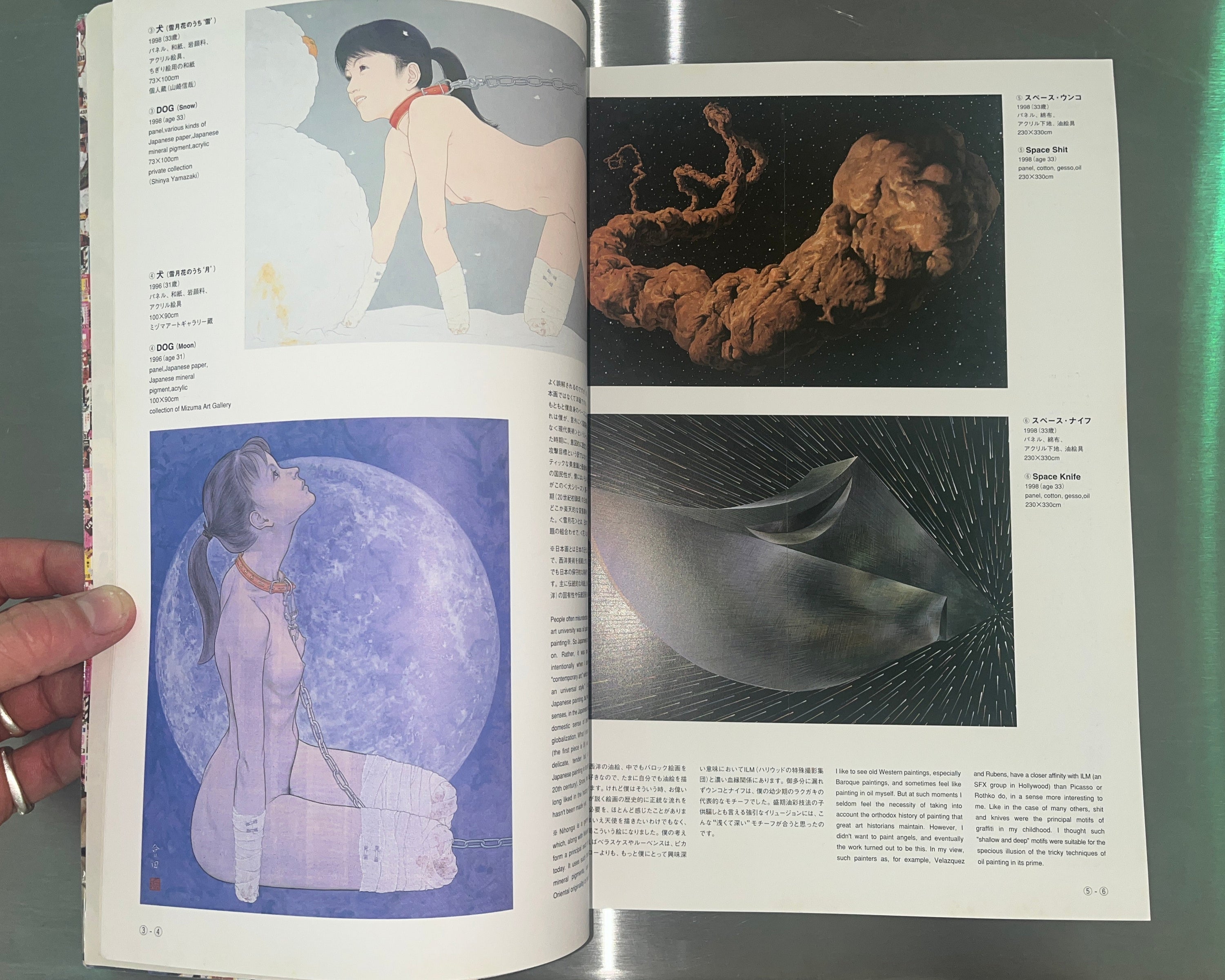 Open book with artistic illustrations of a woman and abstract shapes on a metallic surface.