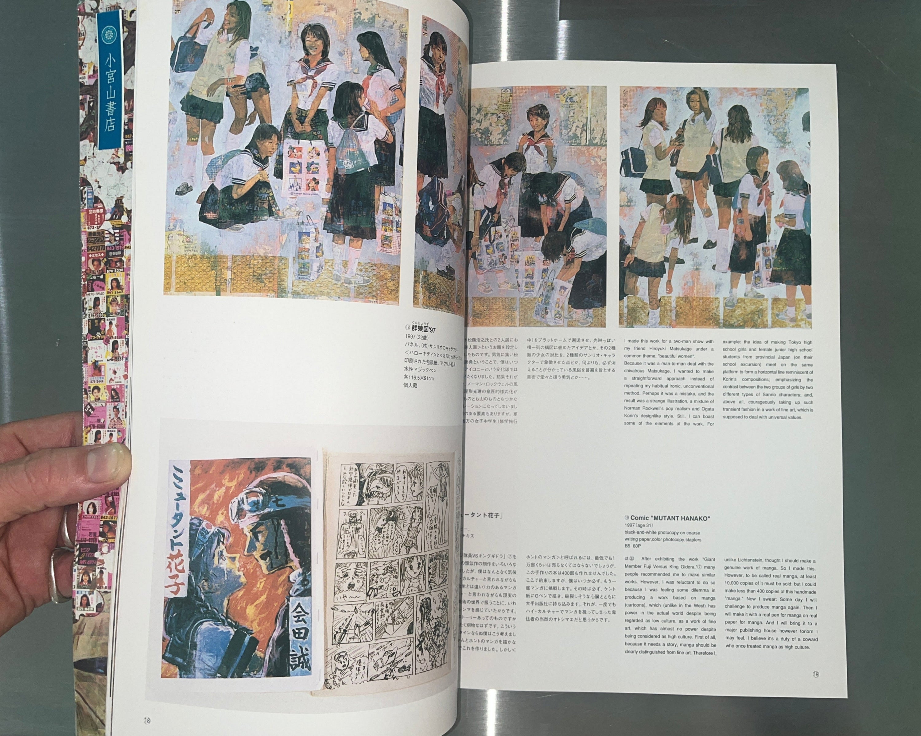 Open book with illustrations and text on a metallic surface