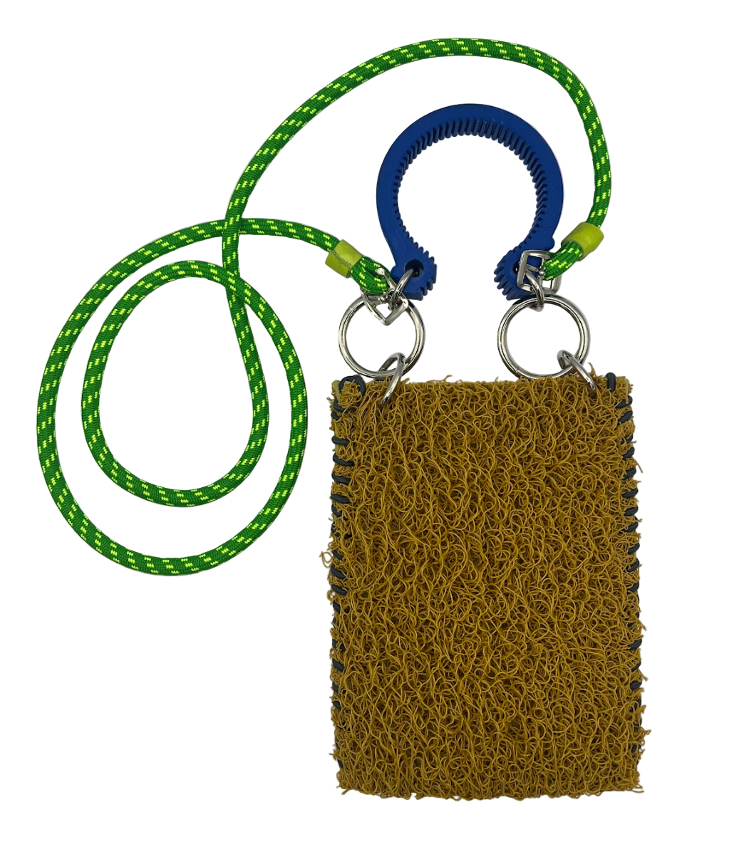 mustard textured pouch with green and blue ring on a white background